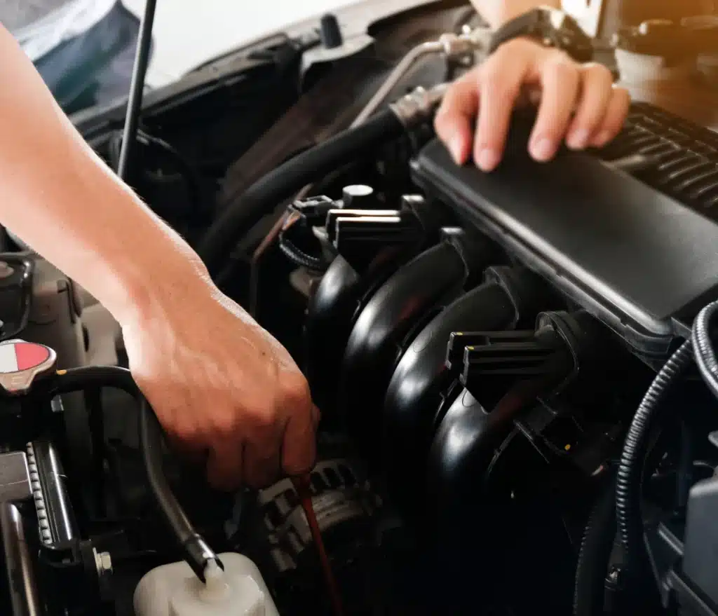 Trustworthy Auto mechanic performing engine diagnostics and repair, identifying key signs that a vehicle's engine needs professional attention.