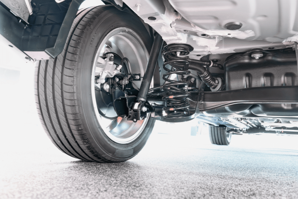 suspension repair, auto repair in Seekonk, MA at Trustworthy Auto, Close-up of a car's suspension system, including coil spring, shock absorber, and tire.